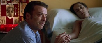 Movie still from “Talk to Her” (2002), directed by Pedro Almodóvar – A person sitting on a couch; Close Up shot, Low angle