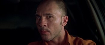 Movie still from “Talk to Her” (2002), directed by Pedro Almodóvar – A person wearing an orange shirt; Close Up shot, Low angle