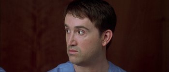 Movie still from “Talk to Her” (2002), directed by Pedro Almodóvar – A person looking at the camera; Close Up shot, Over the shoulder angle