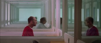 Movie still from “Talk to Her” (2002), directed by Pedro Almodóvar – A man sitting in front of a mirror in a room; Wide shot, Over the shoulder angle