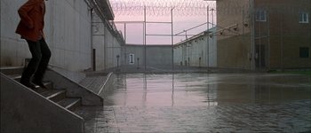 Movie still from “Talk to Her” (2002), directed by Pedro Almodóvar – A view of an outside area of a prison; Extreme Wide shot, High angle