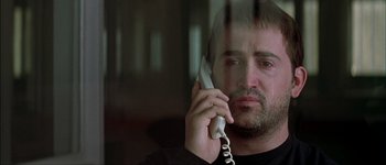 Movie still from “Talk to Her” (2002), directed by Pedro Almodóvar – A man holding a phone up to his ear; Close Up shot, Low angle