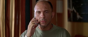 Movie still from “Talk to Her” (2002), directed by Pedro Almodóvar – A man with a bald head talking on a cell phone; Close Up shot, Low angle
