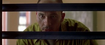 Movie still from “Talk to Her” (2002), directed by Pedro Almodóvar – A person behind a metal fence; Close Up shot, Low angle