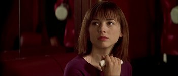 Movie still from “Talk to Her” (2002), directed by Pedro Almodóvar – A woman is holding a remote control in her hand; Close Up shot, Over the shoulder angle