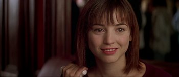 Movie still from “Talk to Her” (2002), directed by Pedro Almodóvar – A person with a smile on their face; Close Up shot, Over the shoulder angle