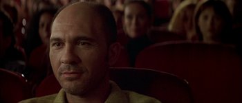 Movie still from “Talk to Her” (2002), directed by Pedro Almodóvar – A person sitting in a movie theater; Close Up shot, Low angle