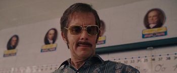 Movie still from “Talladega Nights: The Ballad of Ricky Bobby” (2006), directed by Adam McKay – A person wearing sunglasses; Close Up shot, Low angle