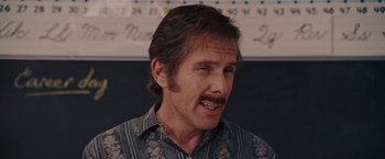 Movie still from “Talladega Nights: The Ballad of Ricky Bobby” (2006), directed by Adam McKay – A person with a mustache; Close Up shot, Over the shoulder angle