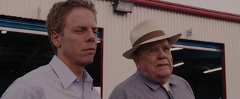 Movie still from “Talladega Nights: The Ballad of Ricky Bobby” (2006), directed by Adam McKay – A man and a man wearing a hat; Close Up shot, Over the shoulder angle