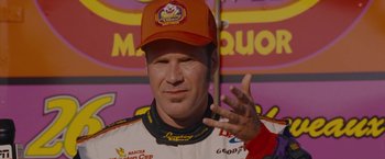Movie still from “Talladega Nights: The Ballad of Ricky Bobby” (2006), directed by Adam McKay – A person wearing a baseball cap; Close Up shot, Overhead angle