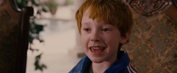 Movie still from “Talladega Nights: The Ballad of Ricky Bobby” (2006), directed by Adam McKay – A young boy smiling for the camera; Close Up shot, High angle