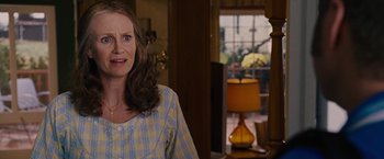 Movie still from “Talladega Nights: The Ballad of Ricky Bobby” (2006), directed by Adam McKay – A woman standing in front of a lamp in a living room; Close Up shot, Over the shoulder angle