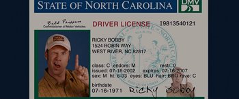 Movie still from “Talladega Nights: The Ballad of Ricky Bobby” (2006), directed by Adam McKay – An image of a driver's license of a man in north carolina; Extreme Close Up shot, Overhead angle