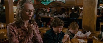 Movie still from “Talladega Nights: The Ballad of Ricky Bobby” (2006), directed by Adam McKay – A woman and two boys sitting at a table eating food; Medium shot, Over the shoulder angle