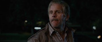 Movie still from “Talladega Nights: The Ballad of Ricky Bobby” (2006), directed by Adam McKay – An older man in a brown jacket looking at the camera; Close Up shot, Low angle