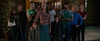 Movie still from “Talladega Nights: The Ballad of Ricky Bobby” (2006), directed by Adam McKay – A group of people standing in front of a building; Medium shot, Over the shoulder angle