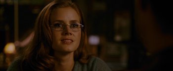 Movie still from “Talladega Nights: The Ballad of Ricky Bobby” (2006), directed by Adam McKay – A person wearing glasses and a sweater; Close Up shot, Over the shoulder angle