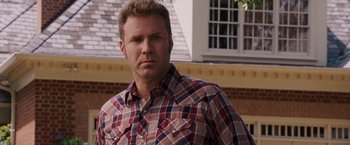 Movie still from “Talladega Nights: The Ballad of Ricky Bobby” (2006), directed by Adam McKay – A person wearing a plaid shirt; Close Up shot, Over the shoulder angle