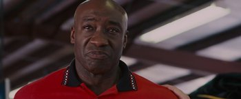 Movie still from “Talladega Nights: The Ballad of Ricky Bobby” (2006), directed by Adam McKay – A person wearing a red shirt; Close Up shot, Low angle