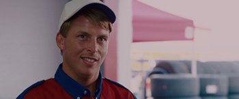 Movie still from “Talladega Nights: The Ballad of Ricky Bobby” (2006), directed by Adam McKay – A person wearing a hat; Close Up shot, Over the shoulder angle