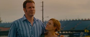 Movie still from “Talladega Nights: The Ballad of Ricky Bobby” (2006), directed by Adam McKay – A man and a woman standing next to each other; Close Up shot, Low angle