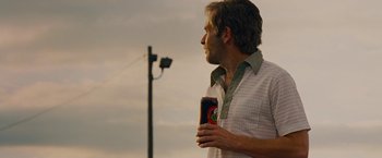 Movie still from “Talladega Nights: The Ballad of Ricky Bobby” (2006), directed by Adam McKay – A man holding a can of beer in his hand; Medium shot, Low angle