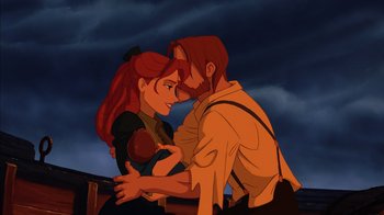 Movie still from “Tarzan” (1999), directed by Kevin Lima – A man and a woman embracing each other in front of a cloudy sky; Medium shot, Low angle