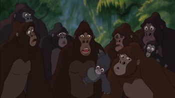 Movie still from “Tarzan” (1999), directed by Kevin Lima – A group of monkeys standing next to each other in a forest; Medium shot, High angle