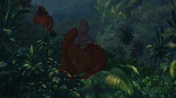 Movie still from “Tarzan” (1999), directed by Kevin Lima – An animated scene of a bear sitting on a bear cub in the jungle; Wide shot, Low angle