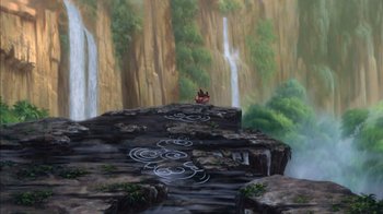 Movie still from “Tarzan” (1999), directed by Kevin Lima – Two people sitting on a cliff near a waterfall; Extreme Wide shot, High angle