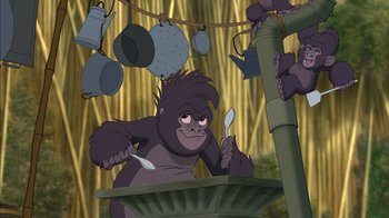 Movie still from “Tarzan” (1999), directed by Kevin Lima – An animated gorilla holding a spoon in his mouth; Medium shot, Low angle