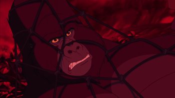 Movie still from “Tarzan” (1999), directed by Kevin Lima – An animated gorilla is in a cage in front of a red background; Close Up shot, Low angle