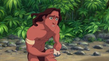 Movie still from “Tarzan” (1999), directed by Kevin Lima – A man with long brown hair is holding something in his hand; Medium shot, Low angle
