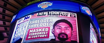 Movie still from “Teenage Mutant Ninja Turtles: Out of the Shadows” (2016), directed by Dave Green – A man in front of a new york post advertisement; Extreme Close Up shot, Low angle