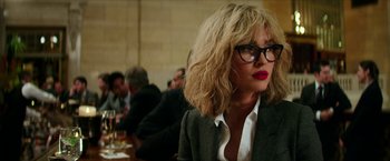 Movie still from “Teenage Mutant Ninja Turtles: Out of the Shadows” (2016), directed by Dave Green – A woman with blonde hair wearing glasses and a jacket; Close Up shot, Over the shoulder angle