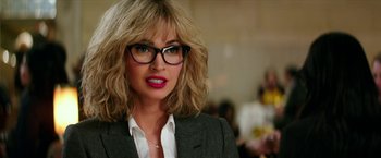 Movie still from “Teenage Mutant Ninja Turtles: Out of the Shadows” (2016), directed by Dave Green – A person wearing glasses and a suit; Close Up shot, Over the shoulder angle