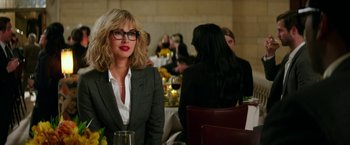 Movie still from “Teenage Mutant Ninja Turtles: Out of the Shadows” (2016), directed by Dave Green – A woman sitting at a table with a glass of red wine; Medium shot, Over the shoulder angle