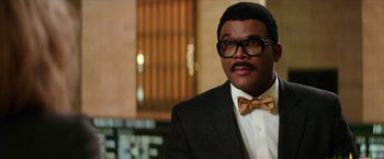 Movie still from “Teenage Mutant Ninja Turtles: Out of the Shadows” (2016), directed by Dave Green – A man wearing a suit and bow tie; Close Up shot, Low angle