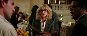 Movie still from “Teenage Mutant Ninja Turtles: Out of the Shadows” (2016), directed by Dave Green – A woman in a suit and glasses holding a knife in her hand; Close Up shot, Over the shoulder angle