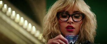 Movie still from “Teenage Mutant Ninja Turtles: Out of the Shadows” (2016), directed by Dave Green – A person wearing glasses and holding a drink; Close Up shot, Over the shoulder angle