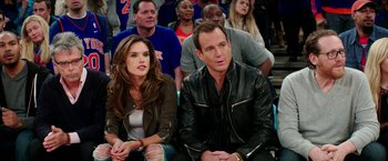 Movie still from “Teenage Mutant Ninja Turtles: Out of the Shadows” (2016), directed by Dave Green – A man and a woman sitting in front of a crowd; Medium shot, Over the shoulder angle