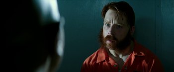 Movie still from “Teenage Mutant Ninja Turtles: Out of the Shadows” (2016), directed by Dave Green – A man with a red beard looking into a mirror; Close Up shot, Over the shoulder angle