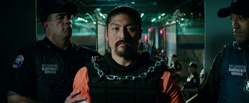 Movie still from “Teenage Mutant Ninja Turtles: Out of the Shadows” (2016), directed by Dave Green – A man with a chain around his neck; Close Up shot, Over the shoulder angle