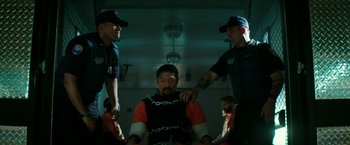 Movie still from “Teenage Mutant Ninja Turtles: Out of the Shadows” (2016), directed by Dave Green – A group of men standing next to each other in a room; Medium shot, Low angle