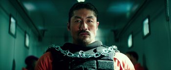 Movie still from “Teenage Mutant Ninja Turtles: Out of the Shadows” (2016), directed by Dave Green – A man with a chain around his neck and chest; Close Up shot, Low angle