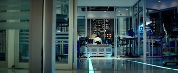 Movie still from “Teenage Mutant Ninja Turtles: Out of the Shadows” (2016), directed by Dave Green – A person working in a lab at night time; Wide shot, Low angle
