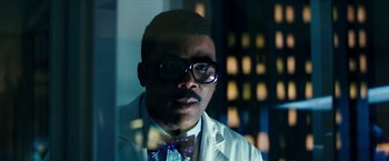 Movie still from “Teenage Mutant Ninja Turtles: Out of the Shadows” (2016), directed by Dave Green – A person wearing a lab coat and bow tie; Close Up shot, Low angle