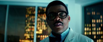 Movie still from “Teenage Mutant Ninja Turtles: Out of the Shadows” (2016), directed by Dave Green – A person wearing glasses and a bow tie; Close Up shot, Low angle