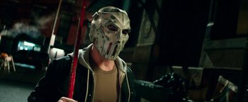 Movie still from “Teenage Mutant Ninja Turtles: Out of the Shadows” (2016), directed by Dave Green – A man with a hockey mask on holding a hockey stick; Close Up shot, Low angle